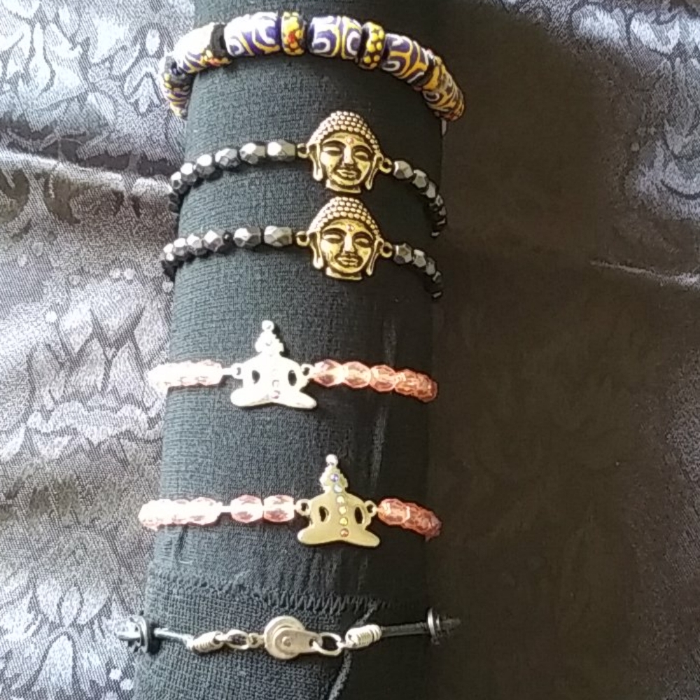 4 Buddist Bracelets and 2 abstract bracelets.